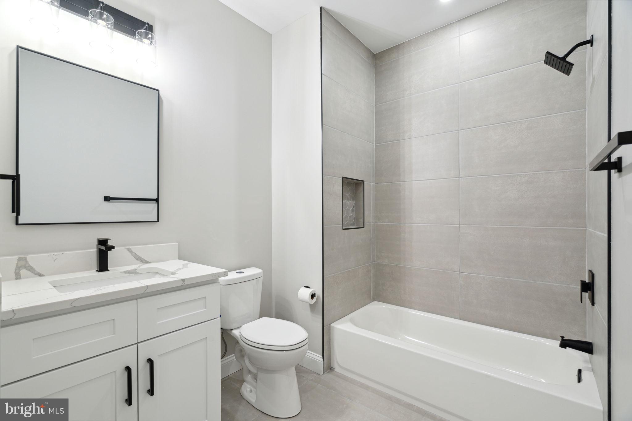 48 Evergreen Lane Phoenixville, PA 19460 - Photo 35 of 42 a bathroom with a toilet a sink a mirror and bathtub