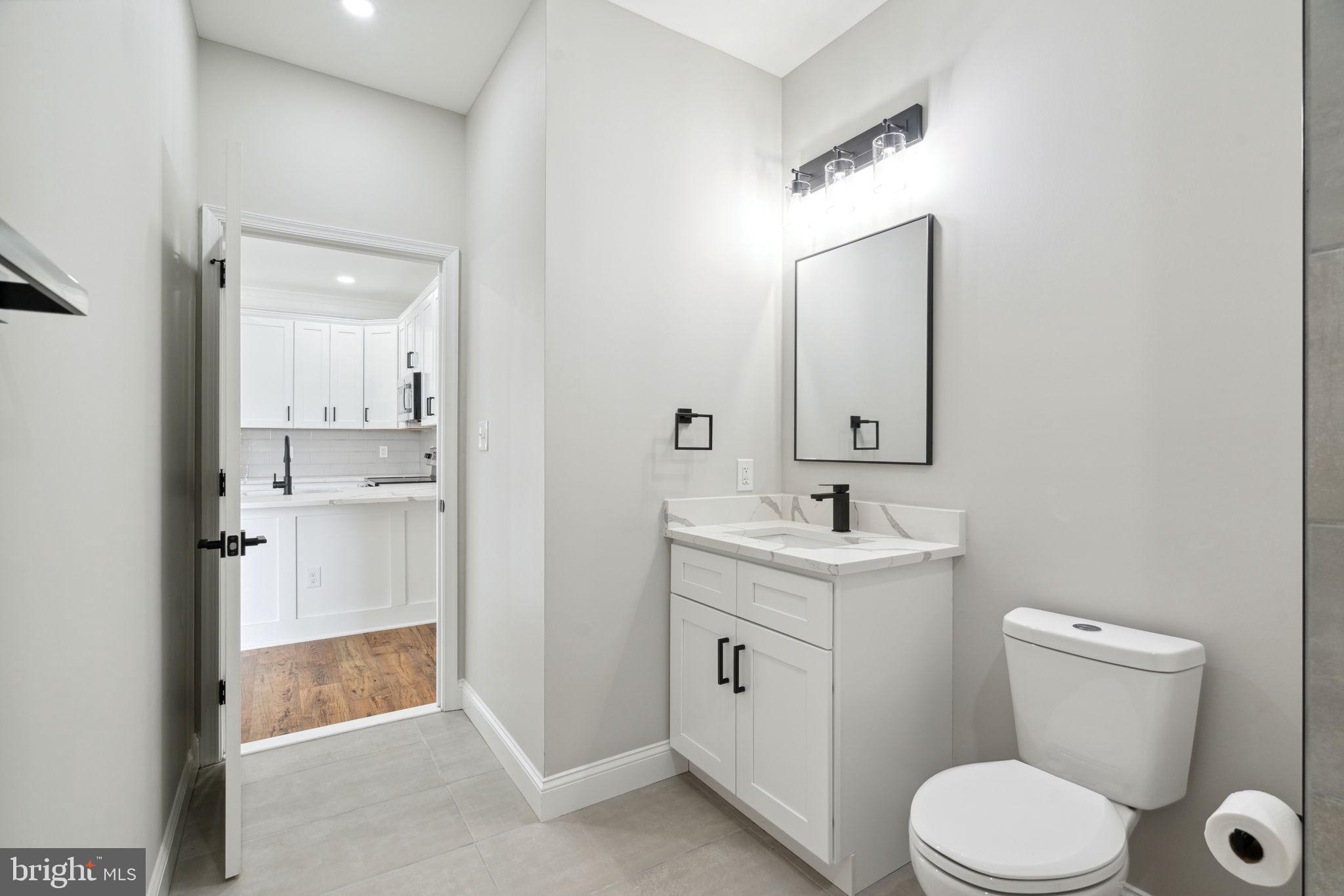 48 Evergreen Lane Phoenixville, PA 19460 - Photo 37 of 42 a bathroom with a toilet a sink a mirror and vanity