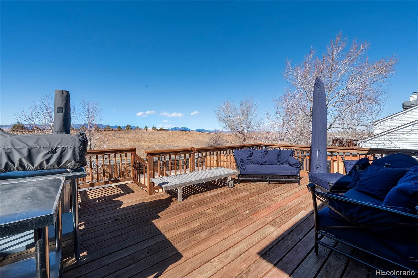 10351 Routt Street Broomfield, CO 80021 - Photo 13 of 31 a view of a balcony with chairs and wooden floor