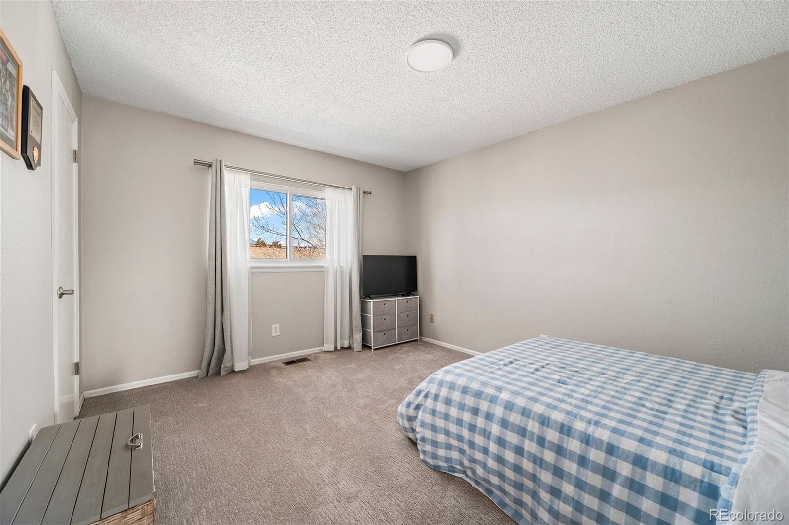 10351 Routt Street Broomfield, CO 80021 - Photo 16 of 31 a bedroom with a bed and window
