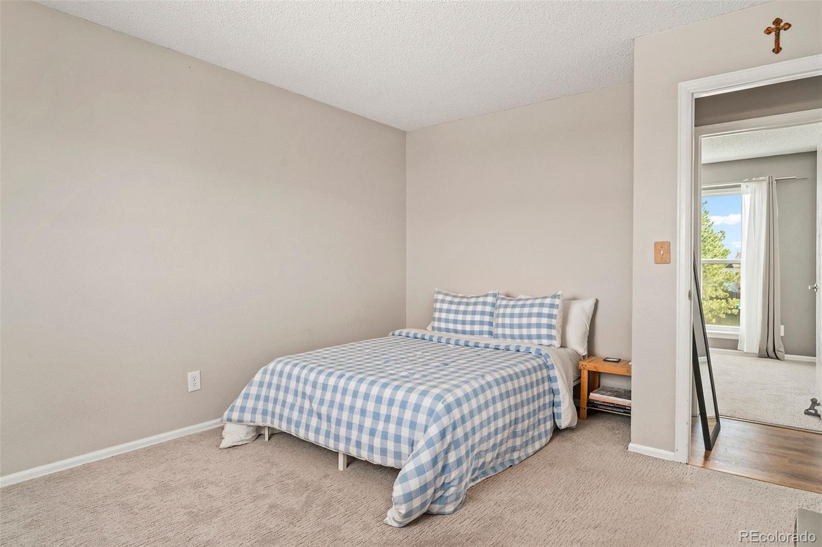 10351 Routt Street Broomfield, CO 80021 - Photo 17 of 31 a bedroom with a bed and a window