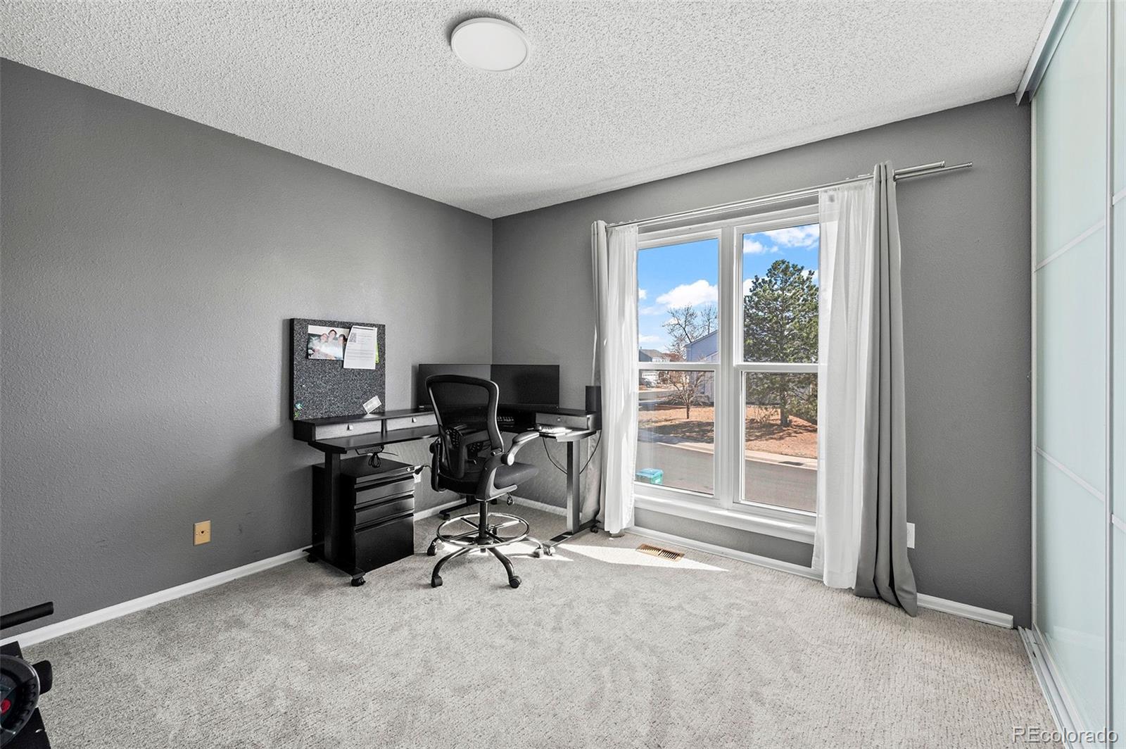 10351 Routt Street Broomfield, CO 80021 - Photo 18 of 31 a view of a workspace with furniture and a window