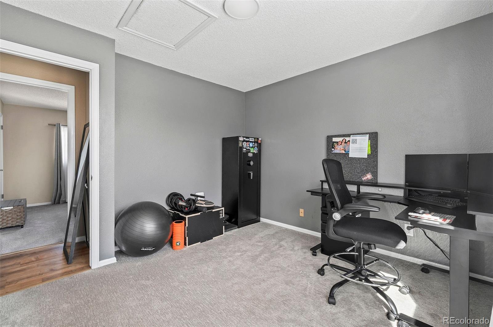 10351 Routt Street Broomfield, CO 80021 - Photo 19 of 31 a view of a workspace with furniture and a window