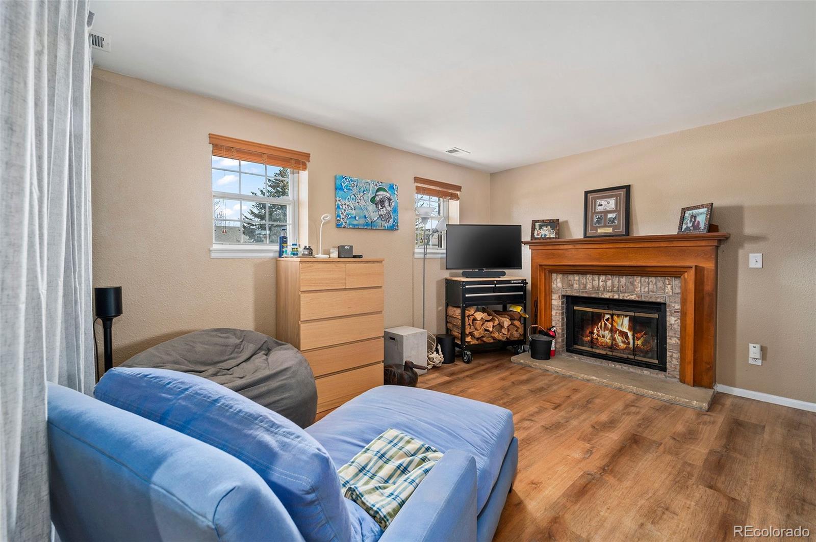 10351 Routt Street Broomfield, CO 80021 - Photo 21 of 31 a living room with furniture and a fireplace