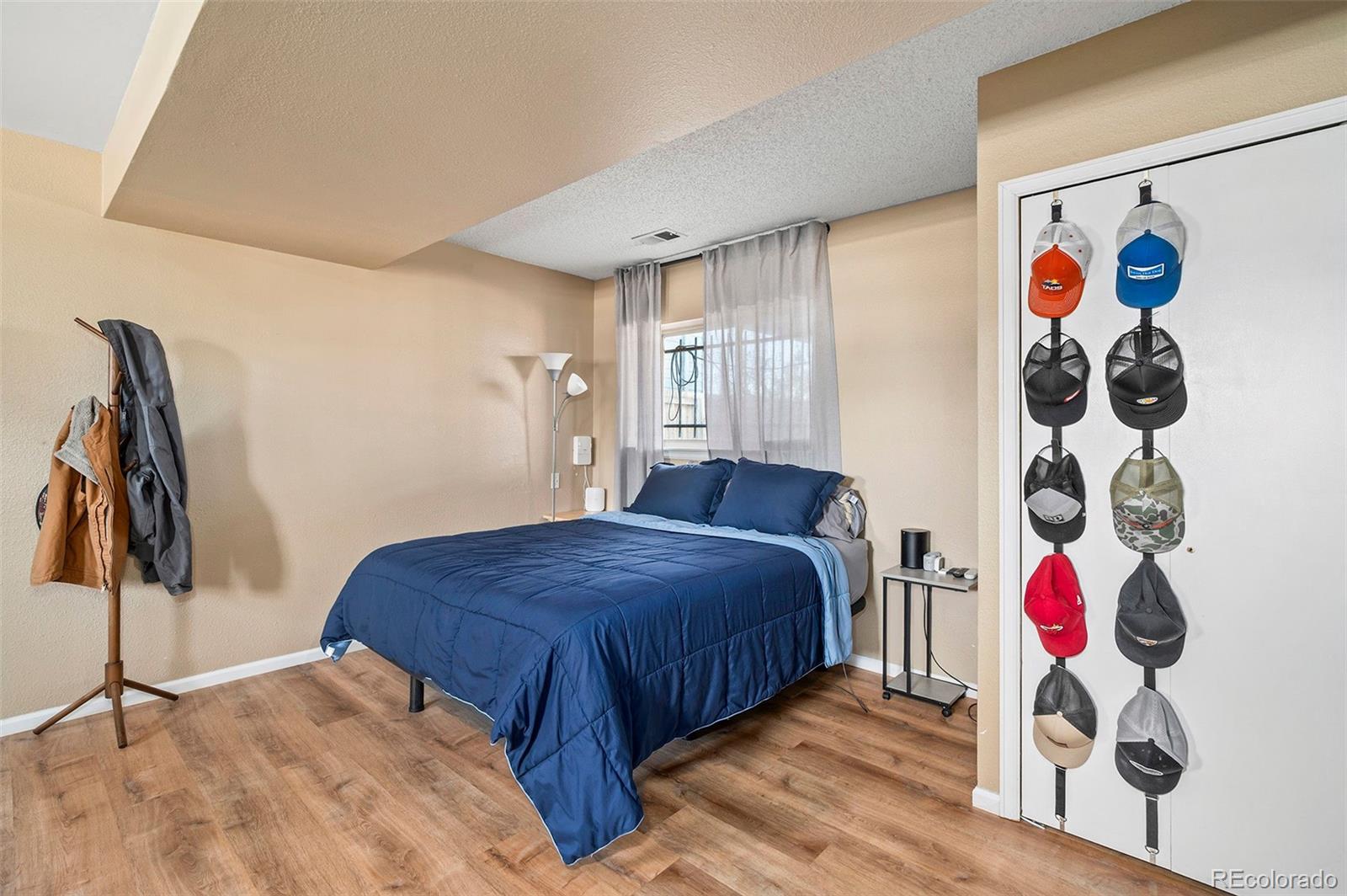 10351 Routt Street Broomfield, CO 80021 - Photo 23 of 31 a bedroom with a bed and a painting on the wall