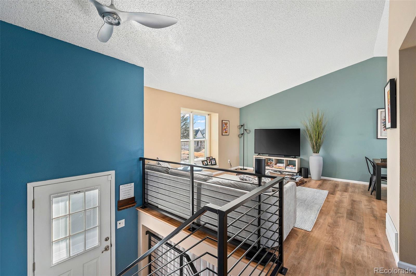 10351 Routt Street Broomfield, CO 80021 - Photo 4 of 31 a living room with furniture and a flat screen tv