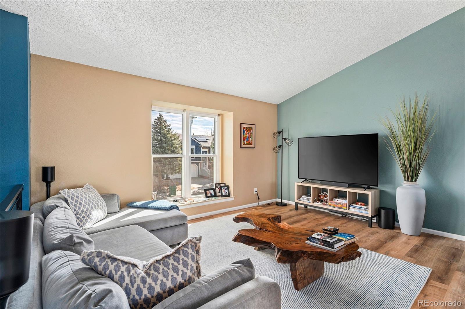 10351 Routt Street Broomfield, CO 80021 - Photo 5 of 31 a living room with furniture and a flat screen tv