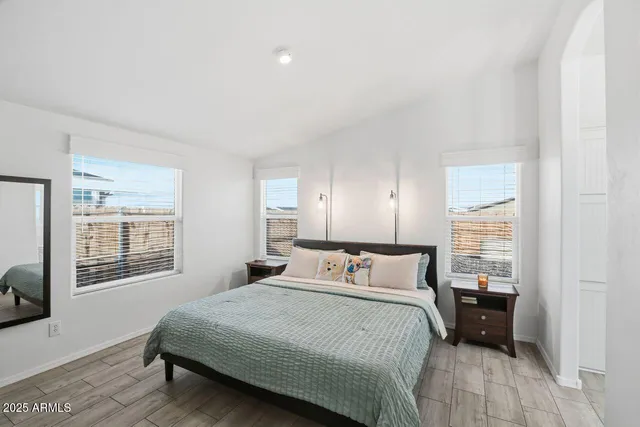 a en suite bathroom with a granite countertop double vanity sink and a mirror