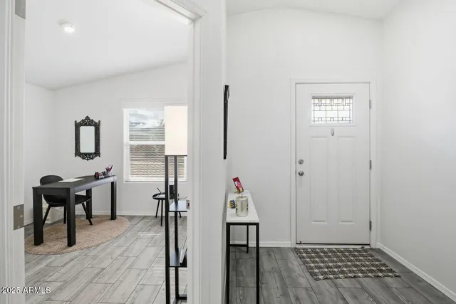 a view of a workspace with furniture and a window