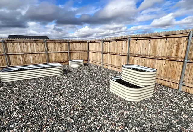 a kitchen with granite countertop a stove a sink and a wooden floors