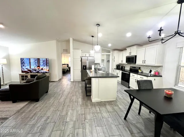 a kitchen with a counter space dining table and chairs