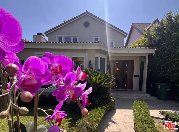 a front view of house with flower pots