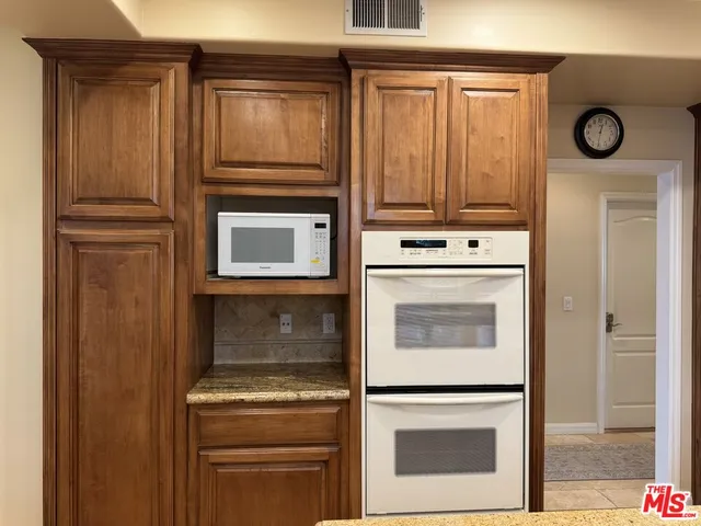 a stove top oven sitting inside of a kitchen