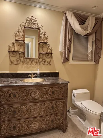 a bathroom with a toilet and a mirror