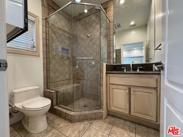 a bathroom with a toilet sink and shower