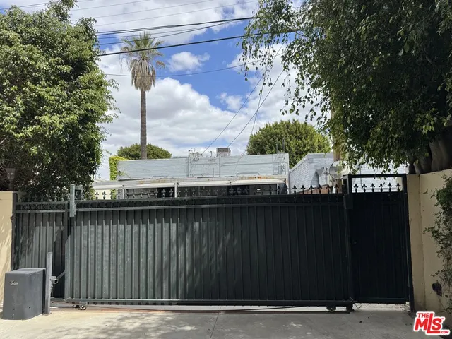 a front view of a house with a tree