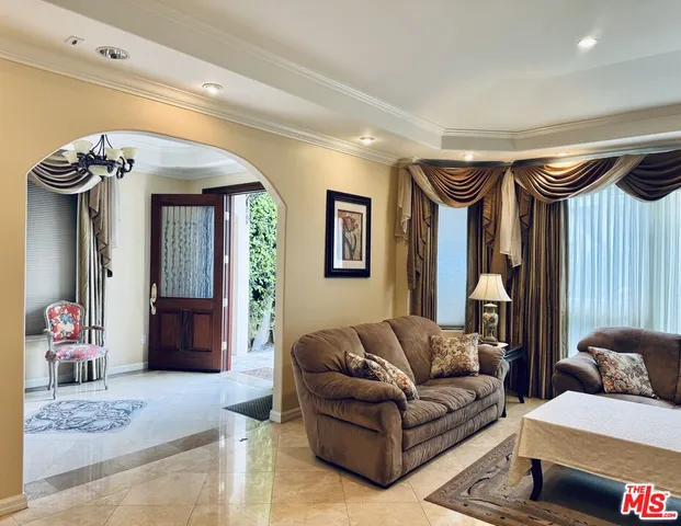 a living room with furniture and a mirror