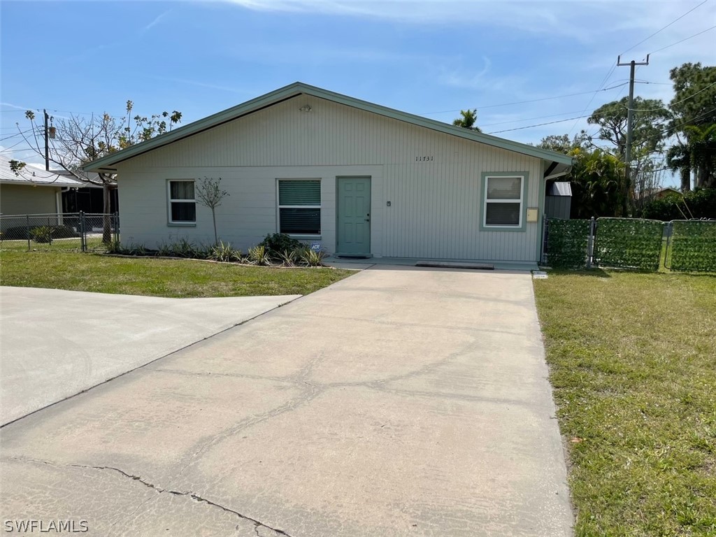 11731 Iona Road Fort Myers, FL 33908 - Photo 1 of 26 a front view of a house with a yard and garage