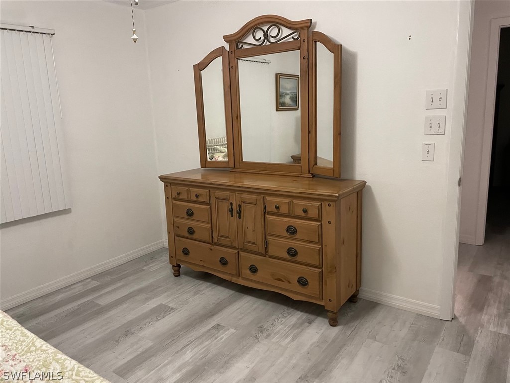 11731 Iona Road Fort Myers, FL 33908 - Photo 13 of 26 a view of a dresser with wooden floor