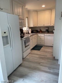 11731 Iona Road Fort Myers, FL 33908 - Photo 16 of 26 a kitchen with white cabinets and white appliances
