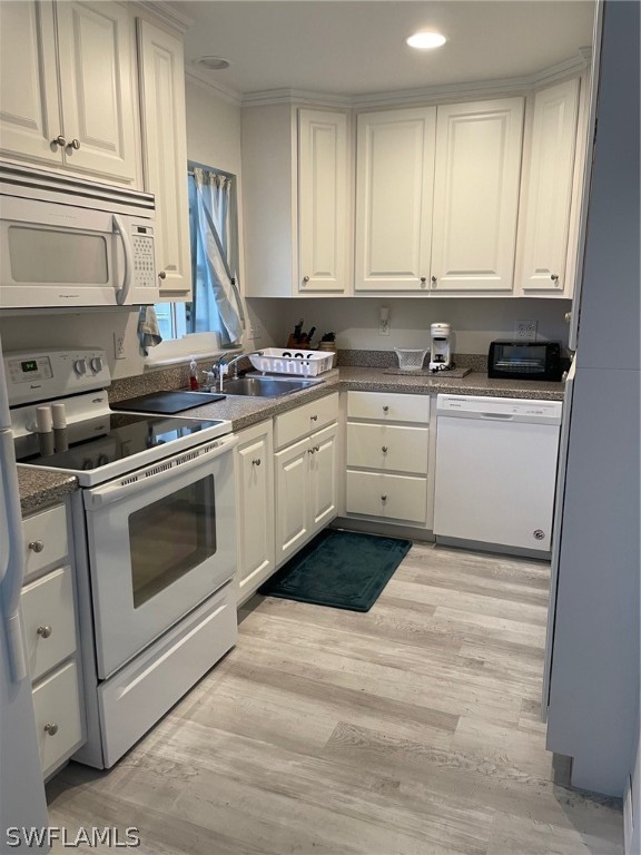 11731 Iona Road Fort Myers, FL 33908 - Photo 17 of 26 a kitchen with a stove oven and white cabinets