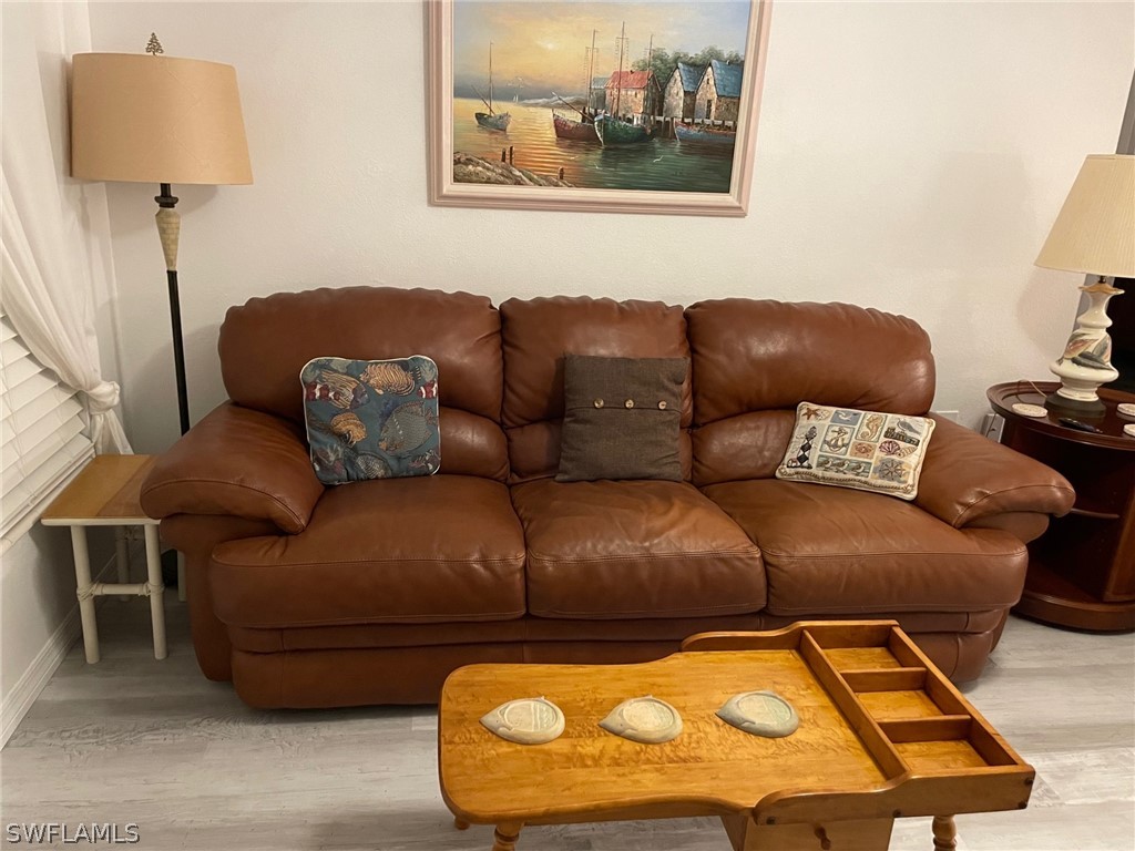 11731 Iona Road Fort Myers, FL 33908 - Photo 2 of 26 a living room with a couch