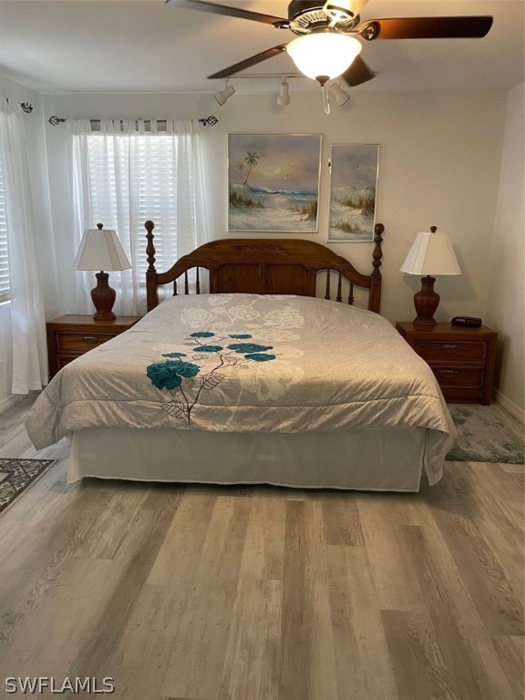 11731 Iona Road Fort Myers, FL 33908 - Photo 7 of 26 a large bed sitting in a bedroom next to a window and a chandelier