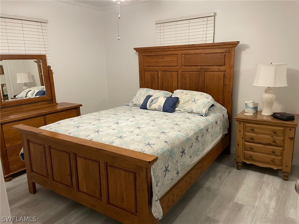11731 Iona Road Fort Myers, FL 33908 - Photo 10 of 26 a bedroom with a bed and a dresser