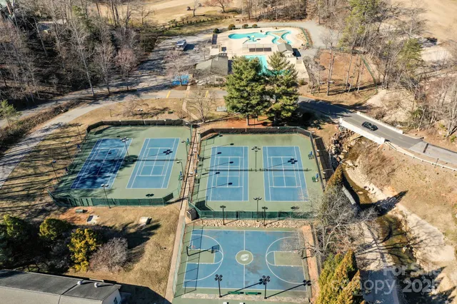 a large white building with a swimming pool in front of it