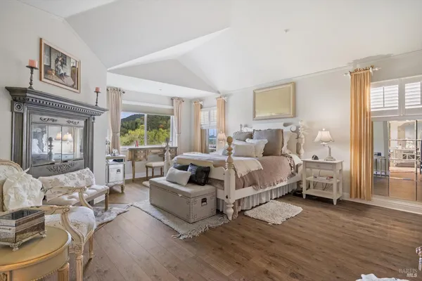 a bedroom with furniture and wooden floor