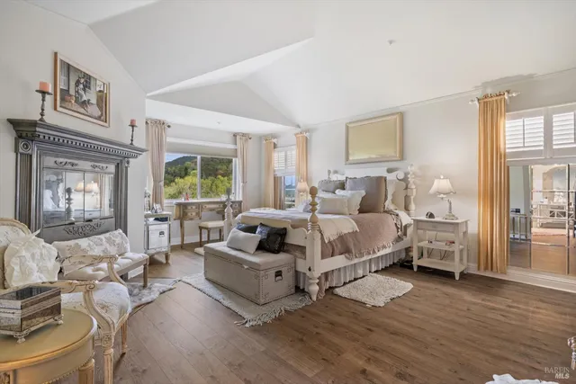 a bedroom with furniture and wooden floor