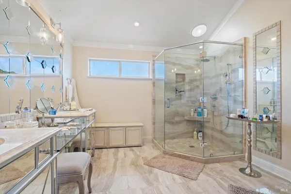 a bathroom with a double vanity sink a mirror and a shower