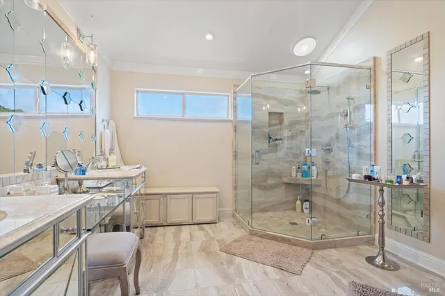 a bathroom with a double vanity sink a mirror and a shower