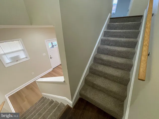a view of staircase with white walls and a window