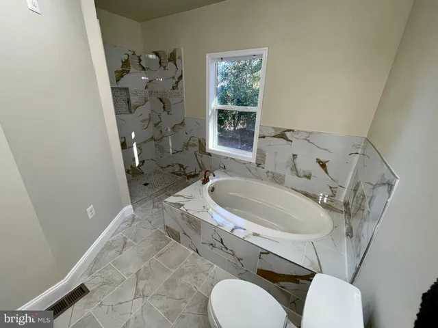 a bathroom with a sink a toilet and tub