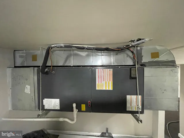 a view of kitchen with stainless steel appliances cabinets