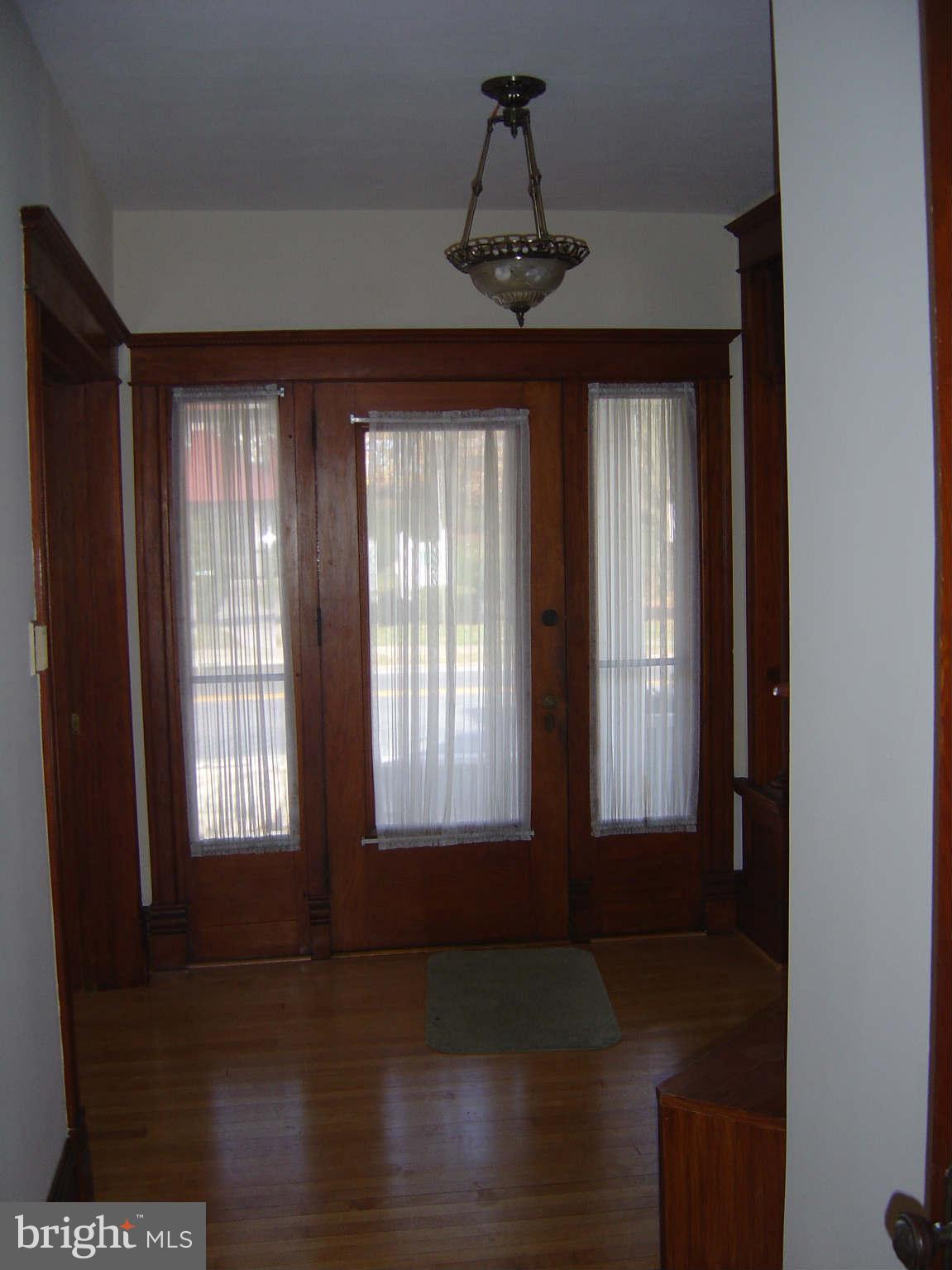 305 Main Street New Windsor, MD 21776 - Photo 12 of 30 a view of an empty room with wooden floor and a window