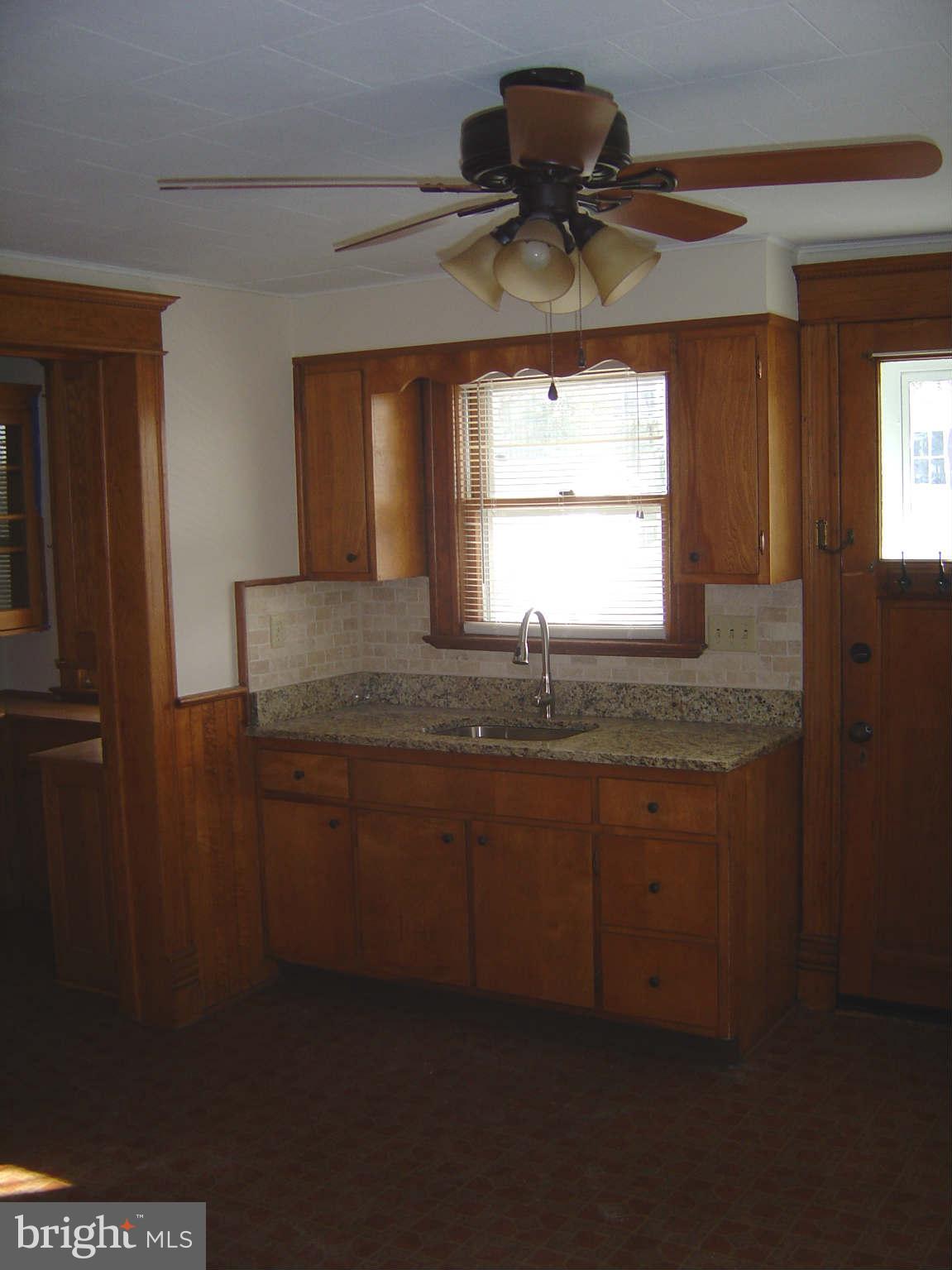 305 Main Street New Windsor, MD 21776 - Photo 21 of 30 a kitchen with granite countertop a sink and a window