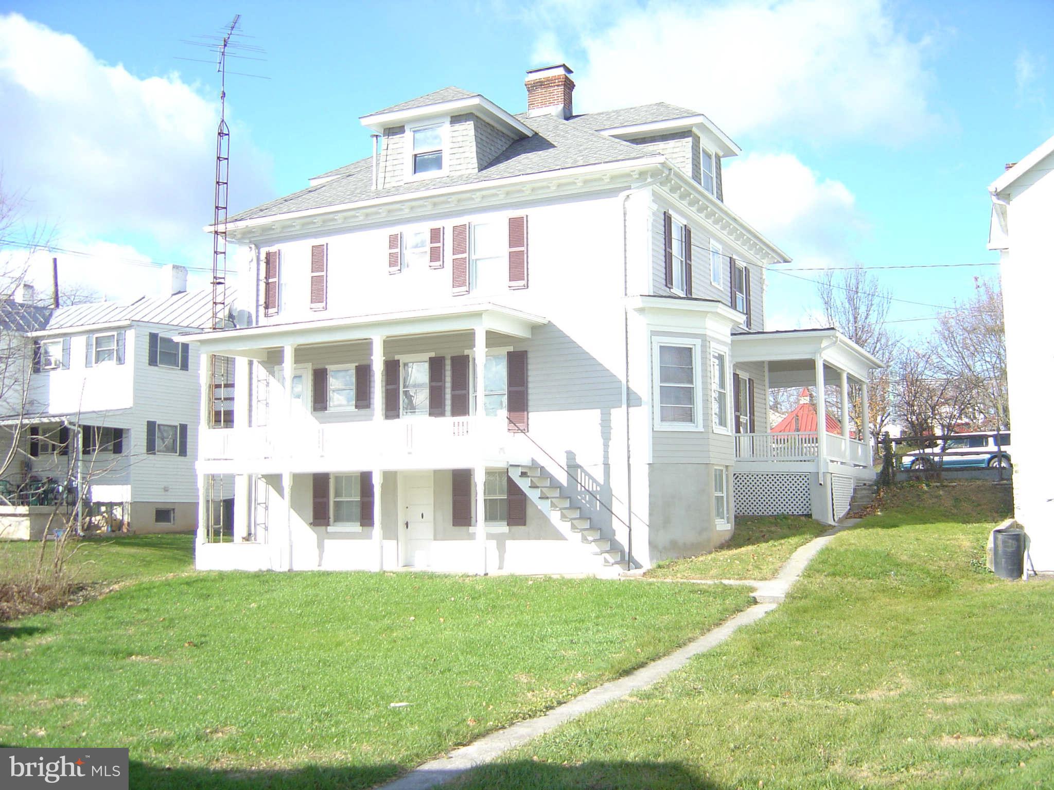305 Main Street New Windsor, MD 21776 - Photo 5 of 30 a front view of a building with a yard