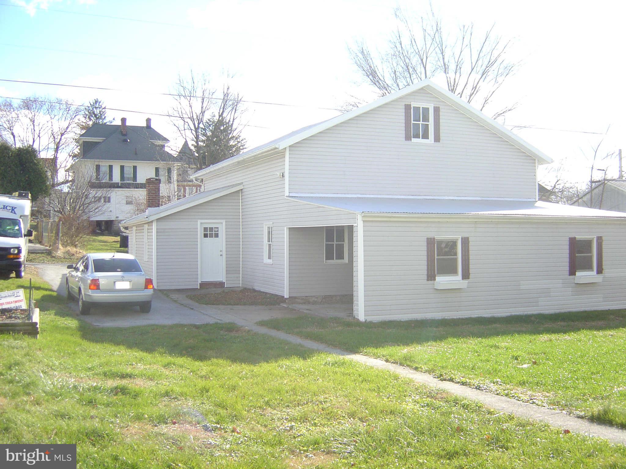 305 Main Street New Windsor, MD 21776 - Photo 9 of 30 a front view of a house with a garden and yard