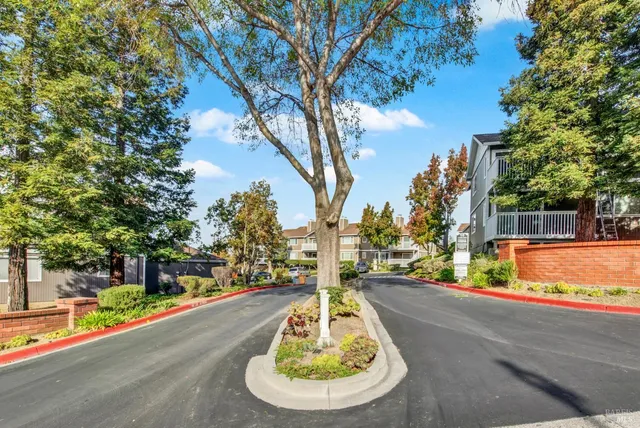 a view of a street with a houses on both side of the road
