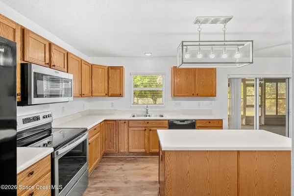a kitchen with stainless steel appliances a sink stove and cabinets