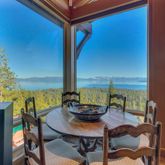 a view of a dining room with a table and chairs