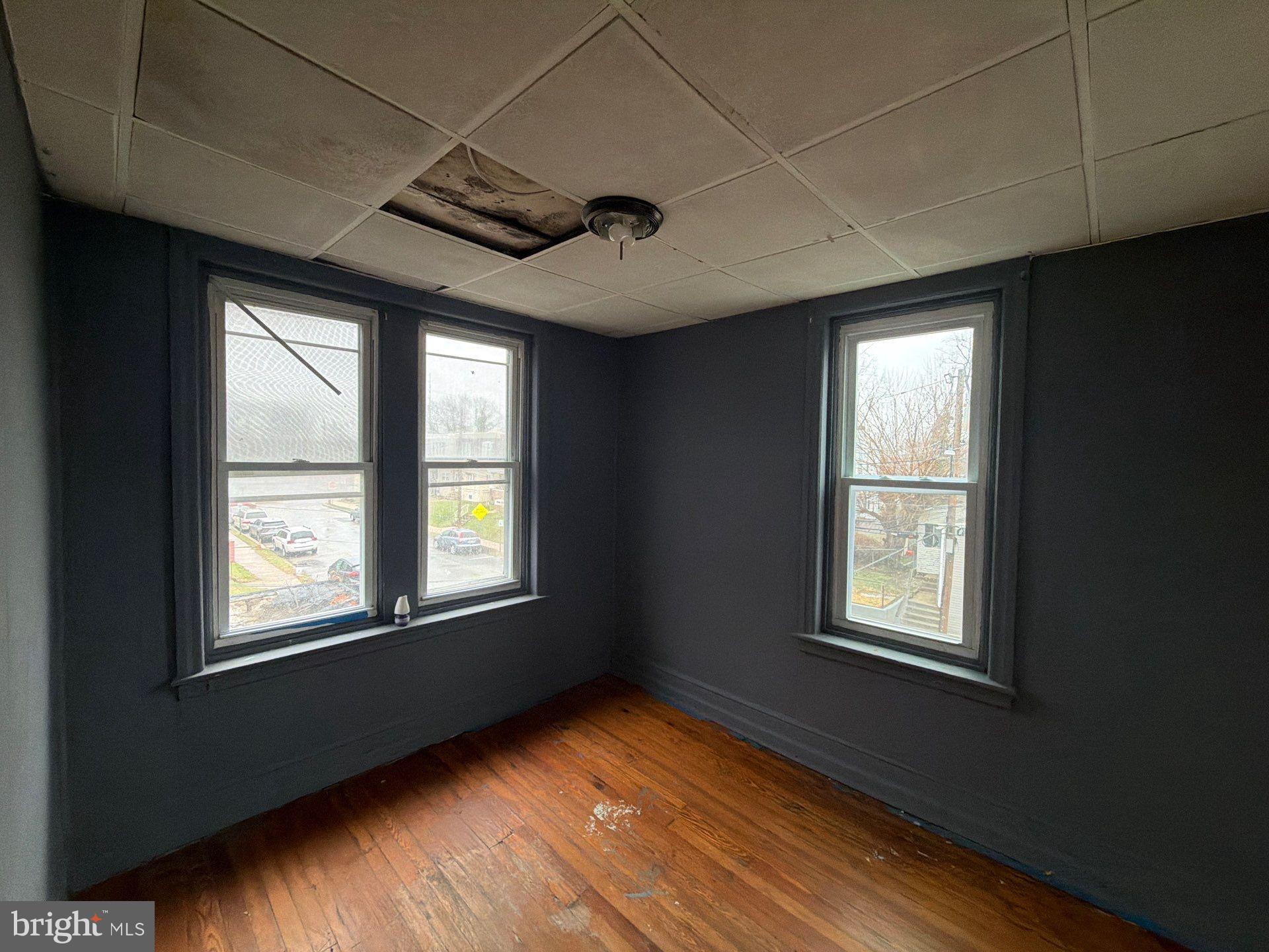 800 West 11th Street Chester, PA 19013 - Photo 13 of 17 a view of an empty room with wooden floor and a window