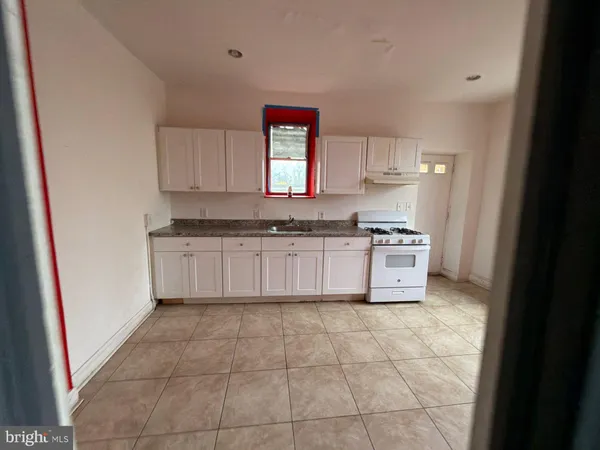 a kitchen with a stove a sink and a refrigerator