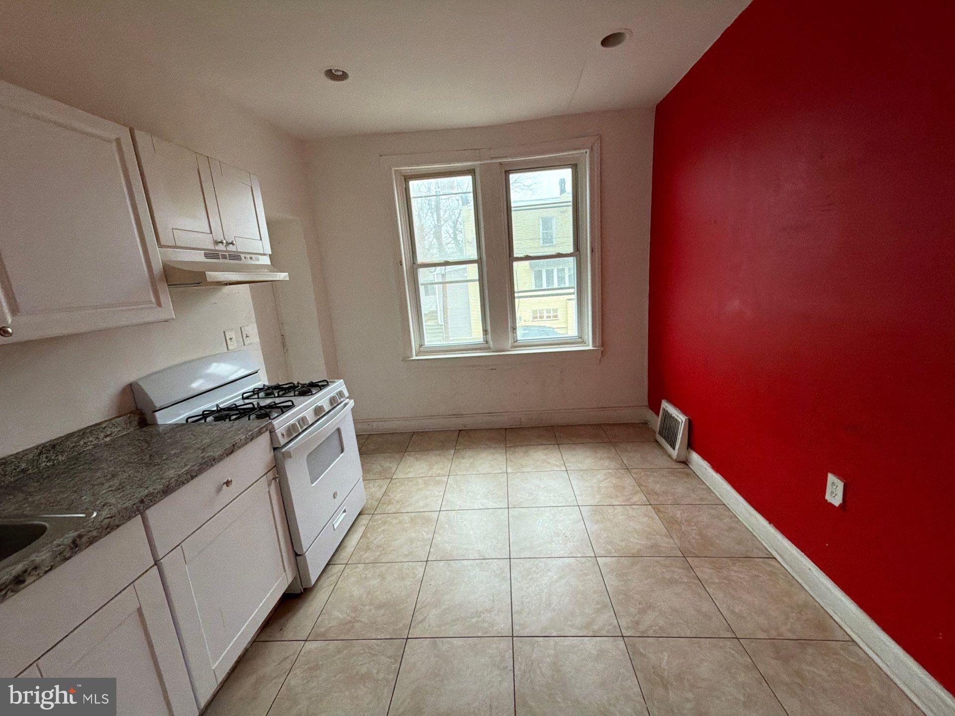 800 West 11th Street Chester, PA 19013 - Photo 4 of 17 a kitchen with stainless steel appliances granite countertop a stove a sink and a counter top space