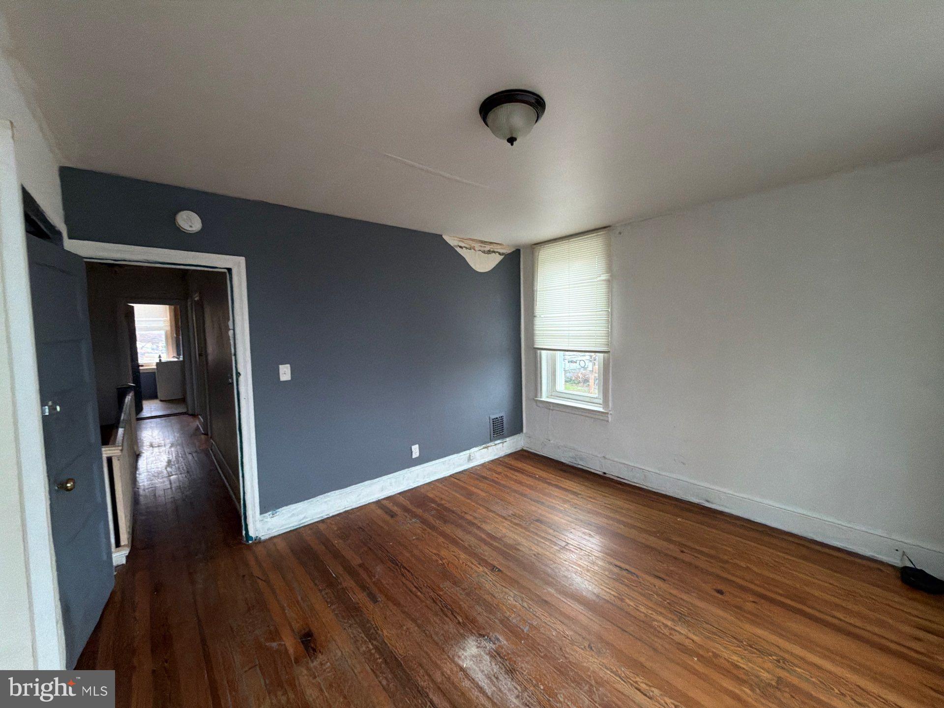 800 West 11th Street Chester, PA 19013 - Photo 8 of 17 wooden floor in an empty room with a window