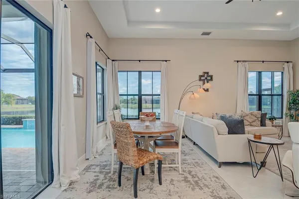 a living room with furniture and a chandelier
