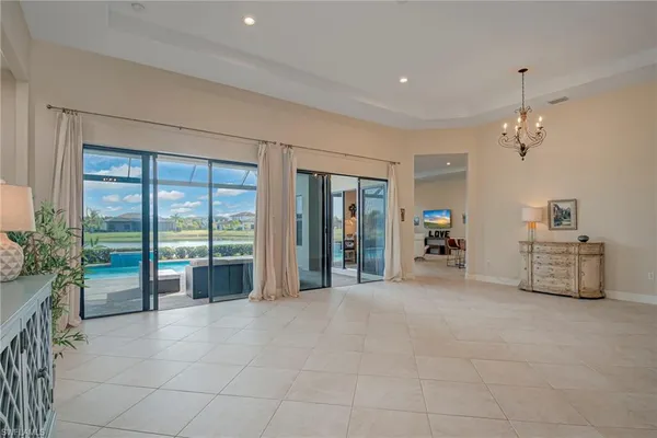 a bedroom with furniture and a chandelier fan