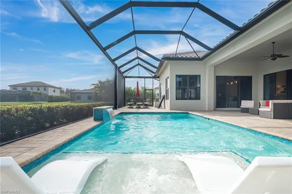 a front view of a house with a garden and garage